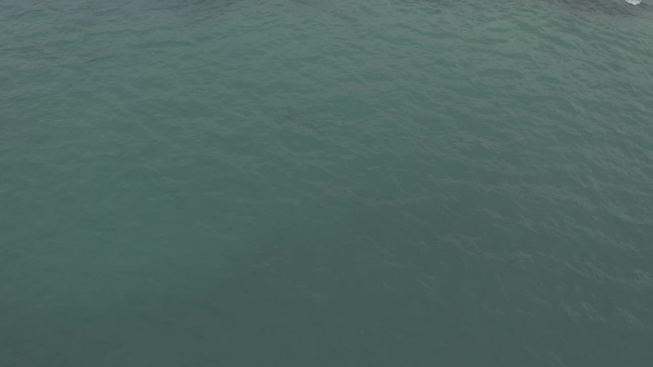 Dark teal ocean surface in Baja California Sur, Mexico, seen from above with faint wave lines and no visible people or objects.