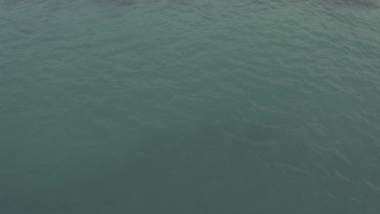 Blue green sea surface in Baja California Sur, Mexico, seen from above with fine ripples and no visible people.