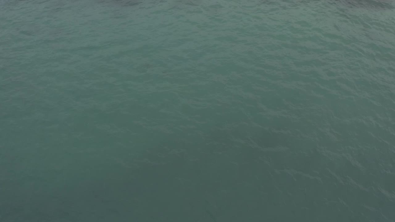 Clear sea water in Baja California Sur, Mexico, with shallow-looking blue green color, small surface waves, and no visible people.