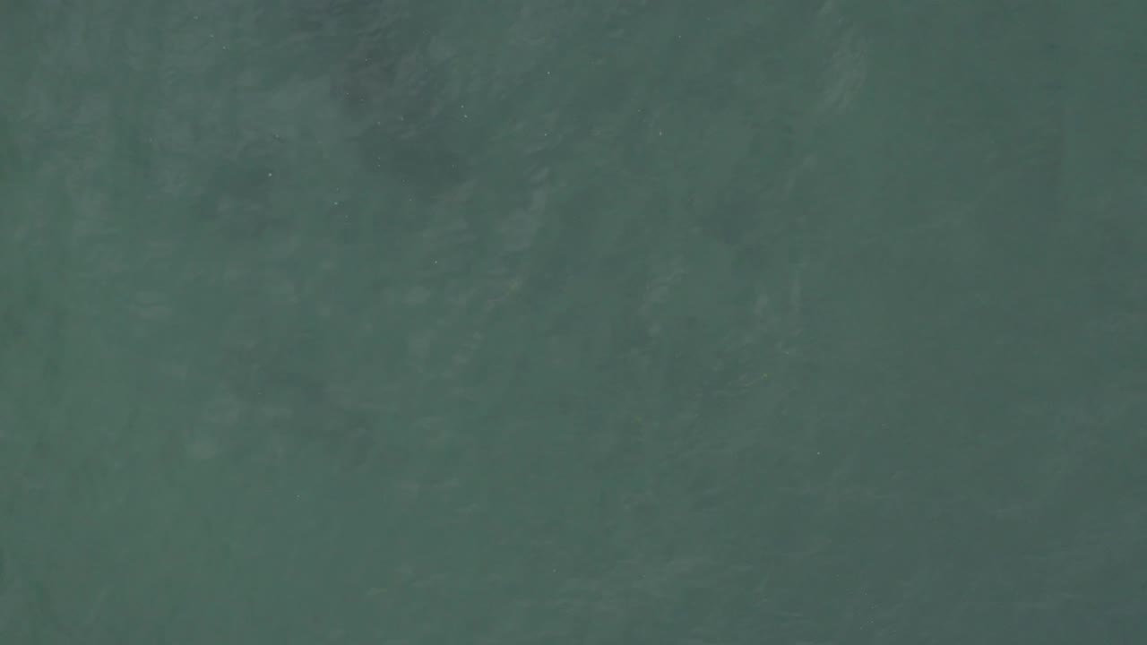 A close downward view of rippled teal ocean water in Baja California Sur shows slight tonal shifts and no visible people.