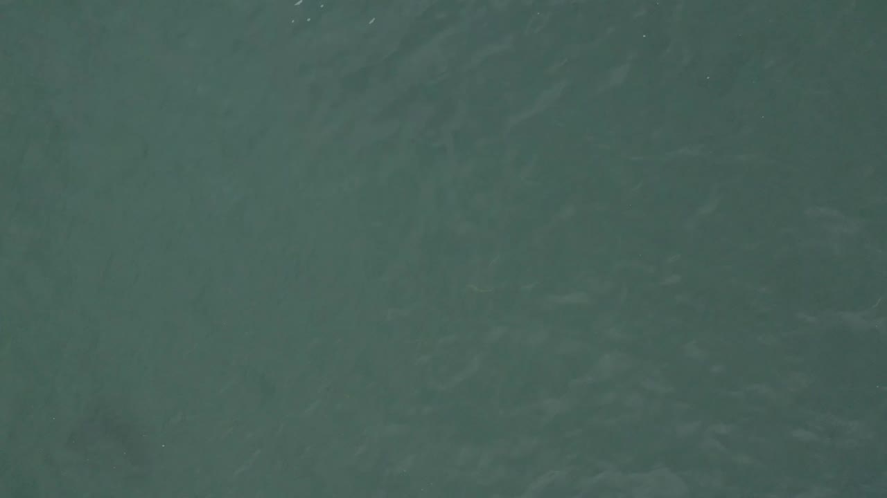 Muted green ocean water in Baja California Sur, Mexico, with slightly darker ripple bands and no visible people.