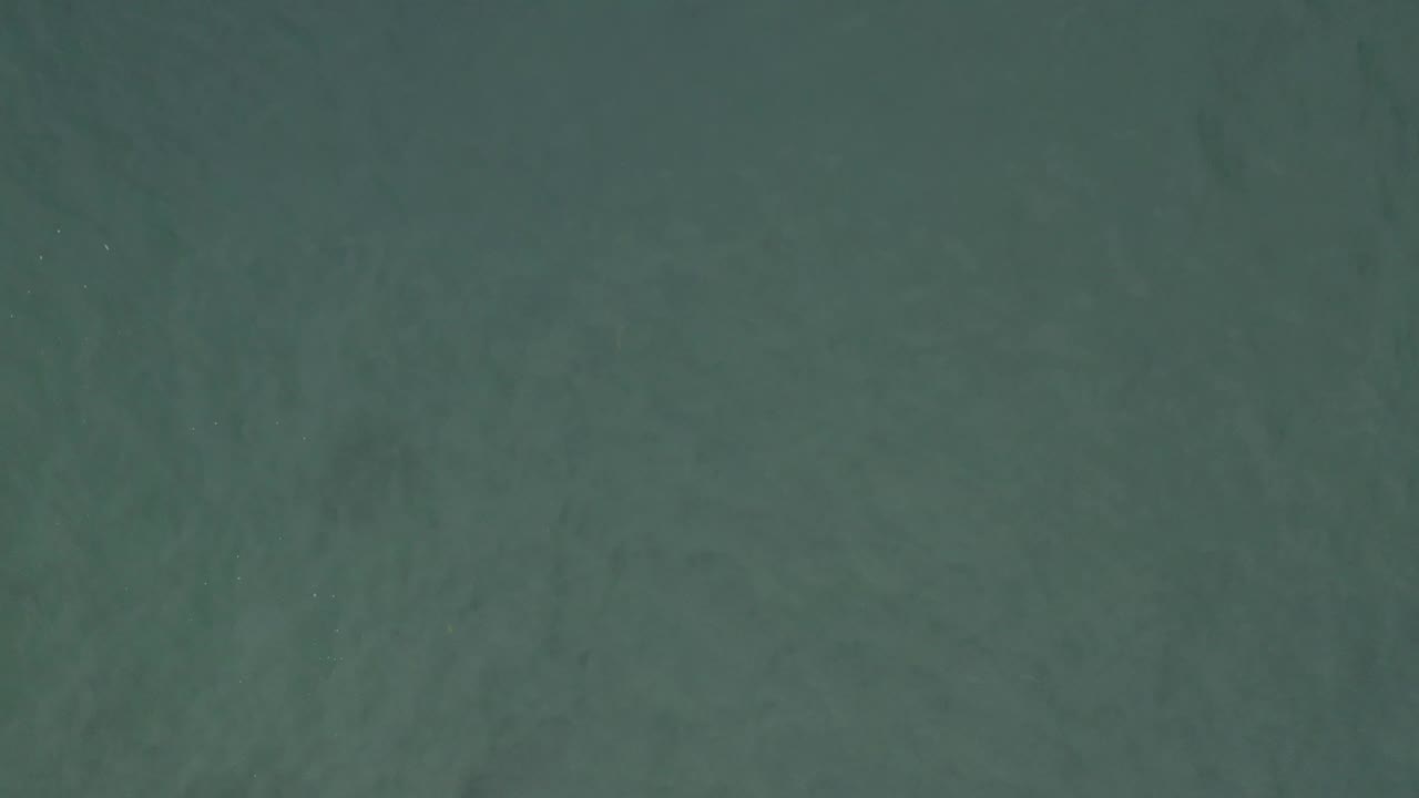 Top-down ocean water in Baja California Sur, Mexico, with muted teal color and no visible people or vessels.