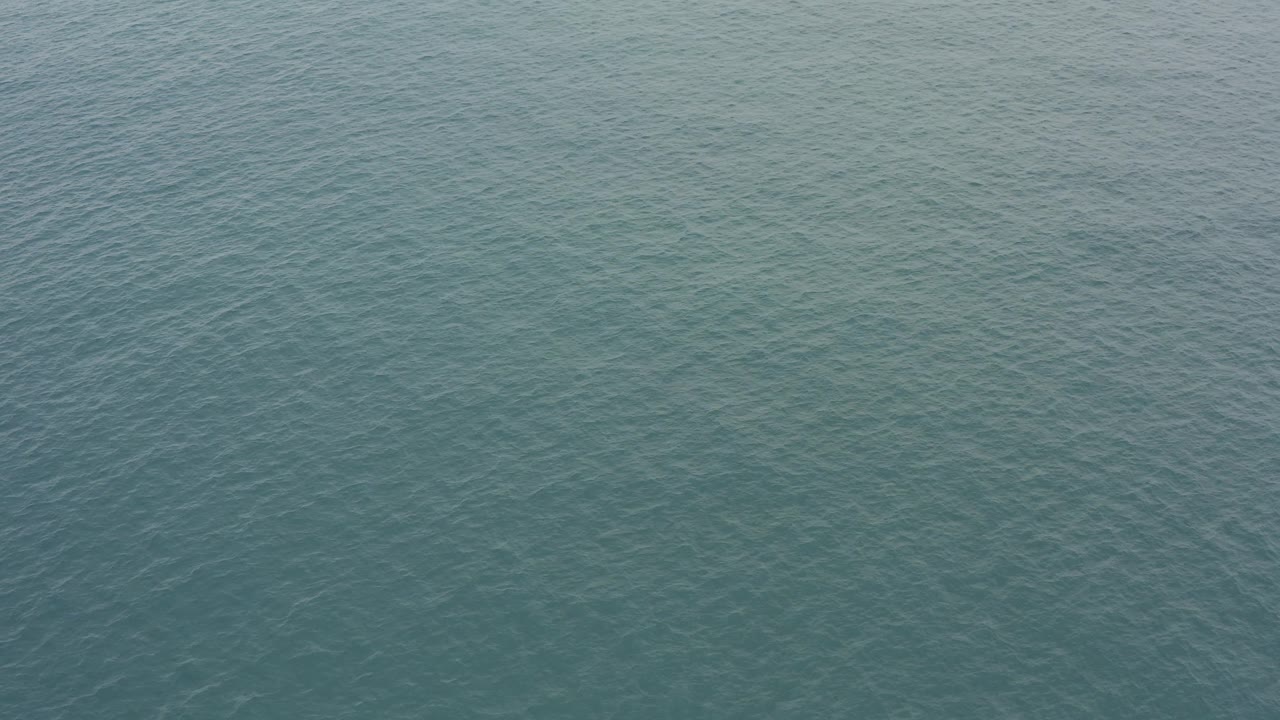 Blue-green water fills the frame in Baja California Sur, with a denser ripple pattern visible near the center and no visible people.