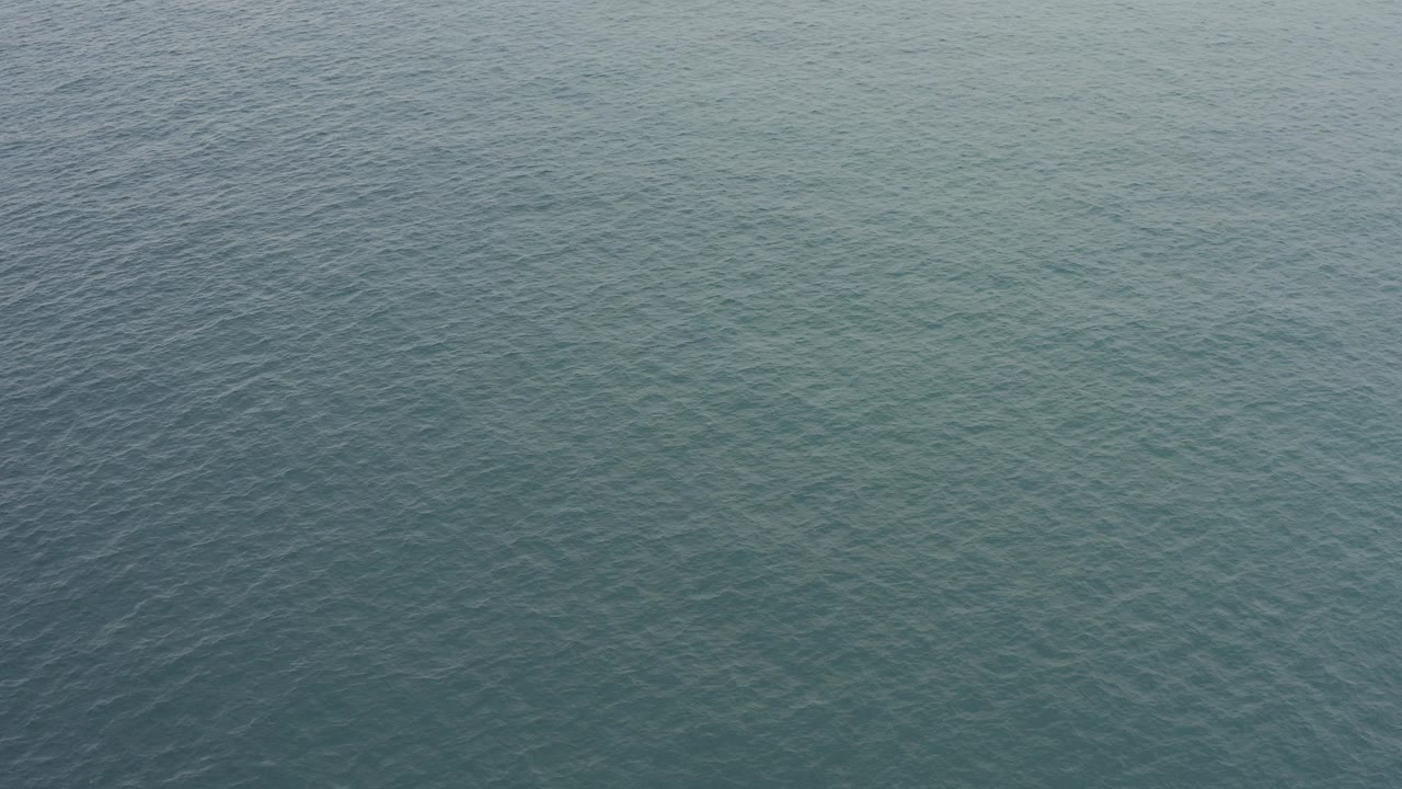 Opening frame of blue-green ocean water in Baja California Sur, Mexico, with fine wind ripples across the surface and no visible people.
