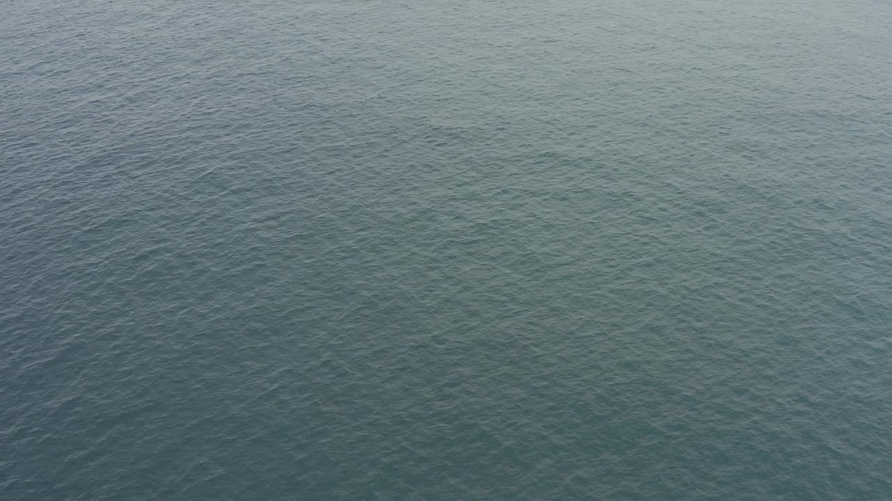 Mid-clip frame of Baja California Sur ocean water with wind-textured ripples and a slightly darker blue-green tone, with no visible people.