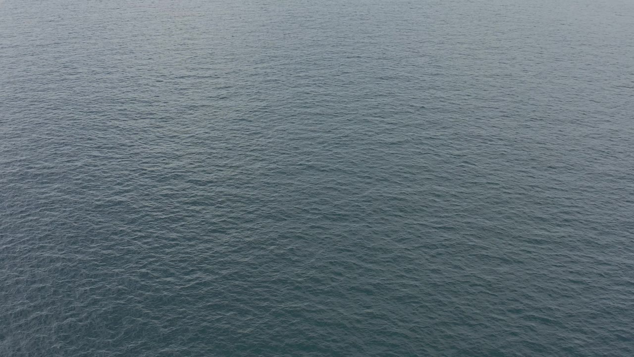 Muted blue water fills the frame in Baja California Sur, with slightly darker ripple patterns and no visible people.