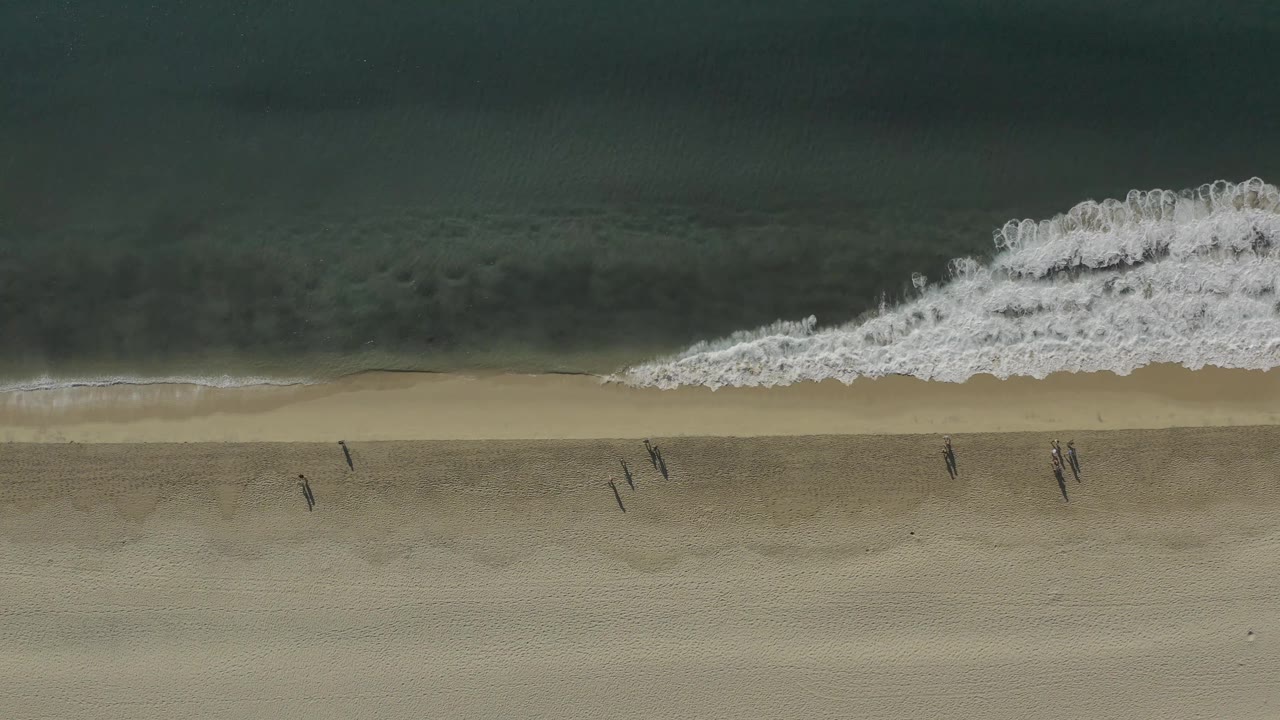 White surf spreads along the shoreline