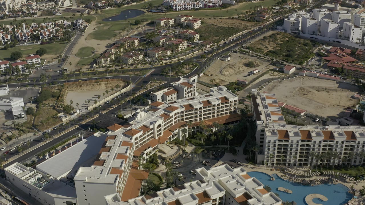 Overhead resort area with roads, golf greens, dry lots, and apartment buildings.