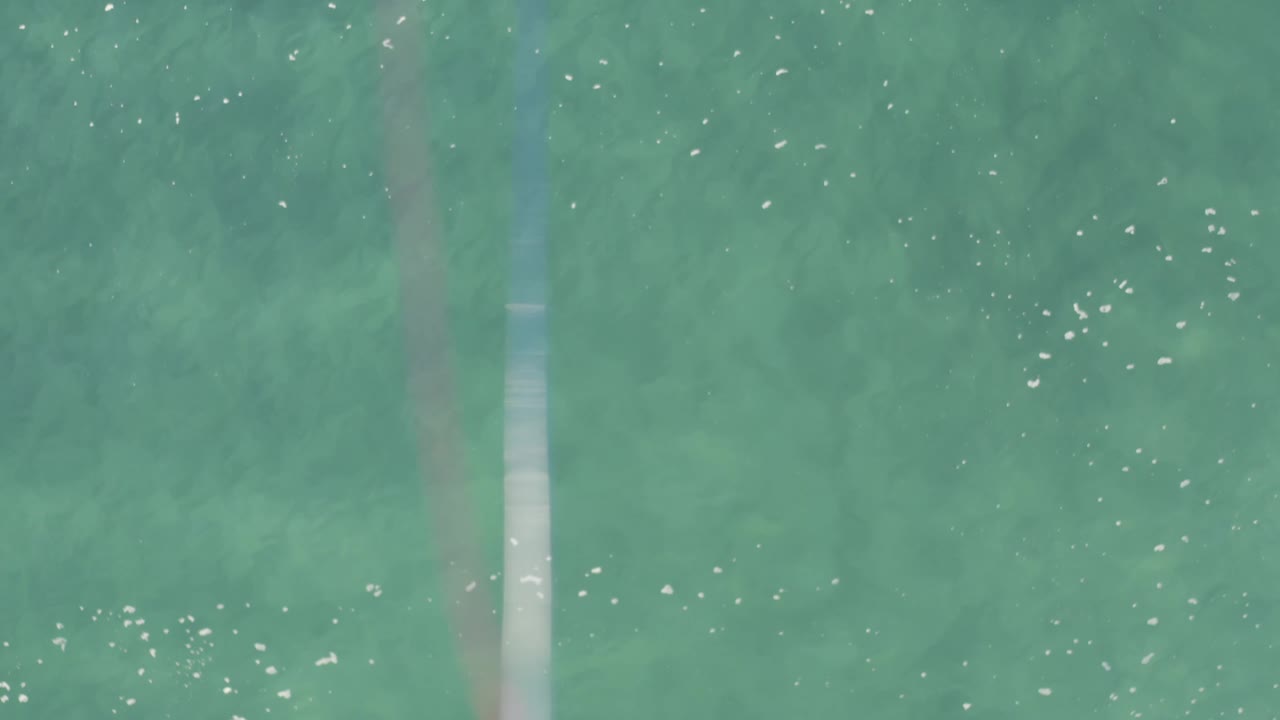 Overhead frame of green-blue coastal water in Baja California Sur, Mexico, with tiny white ripples and no visible people.