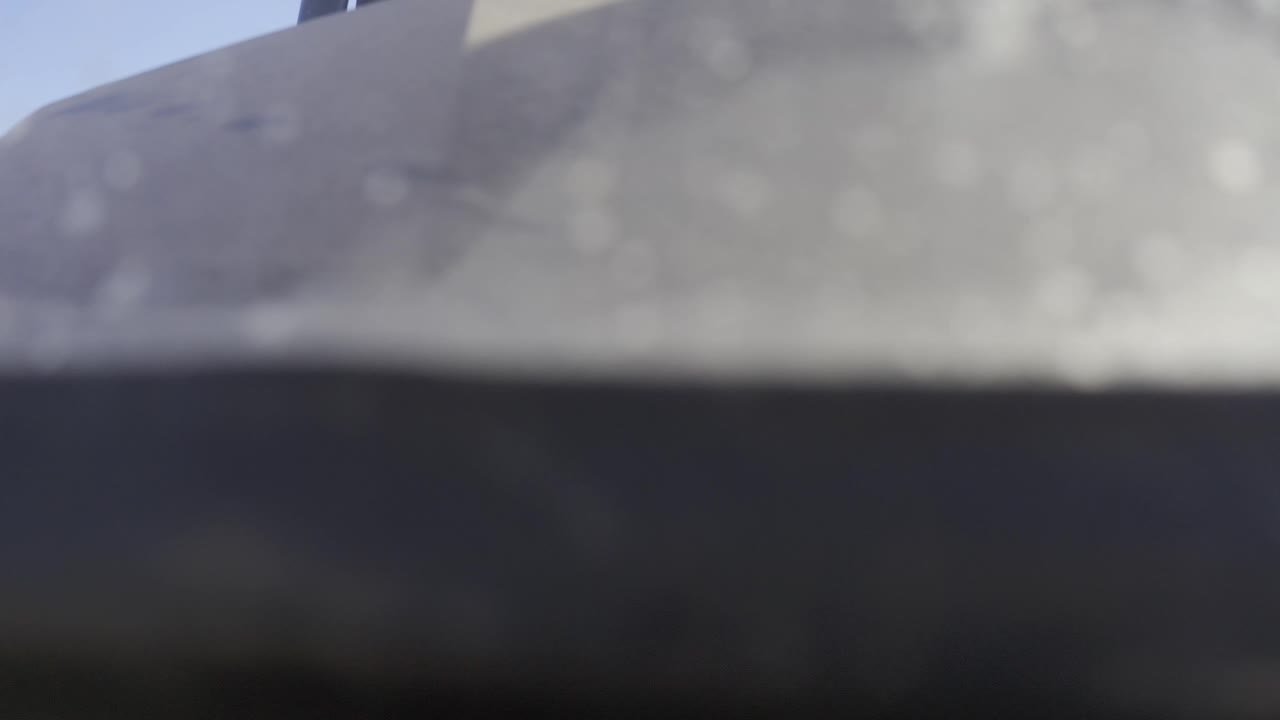 Gray blurred shape stretches across the top with a black-blue band below.