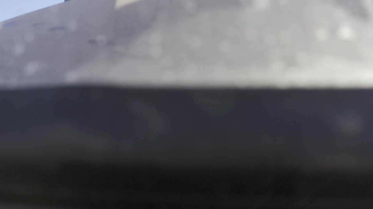 Soft, zoomed grey surface over a black band in Baja California Sur Mexico footage, with low detail and no visible people.