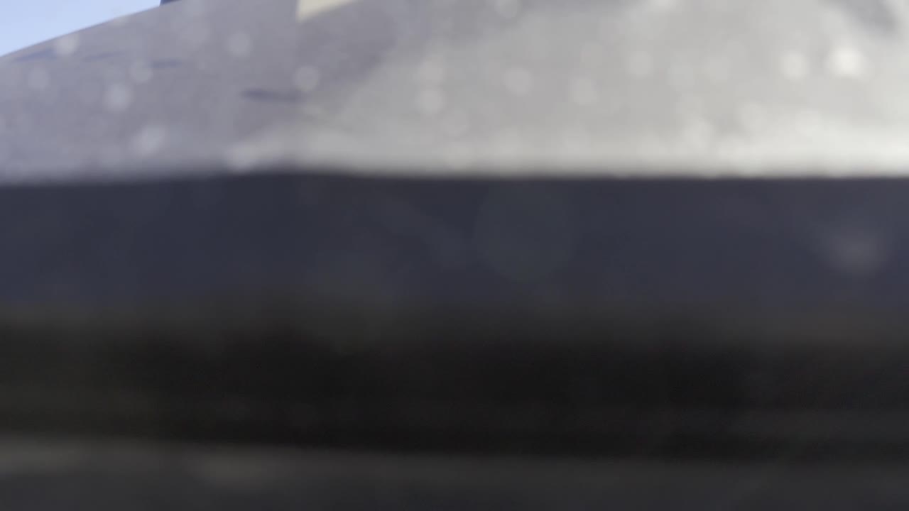 At 0:03, the Baja California Sur Mexico image is a soft close view of a pale surface over a dark underside, with blue sky at the upper left and no visible people.