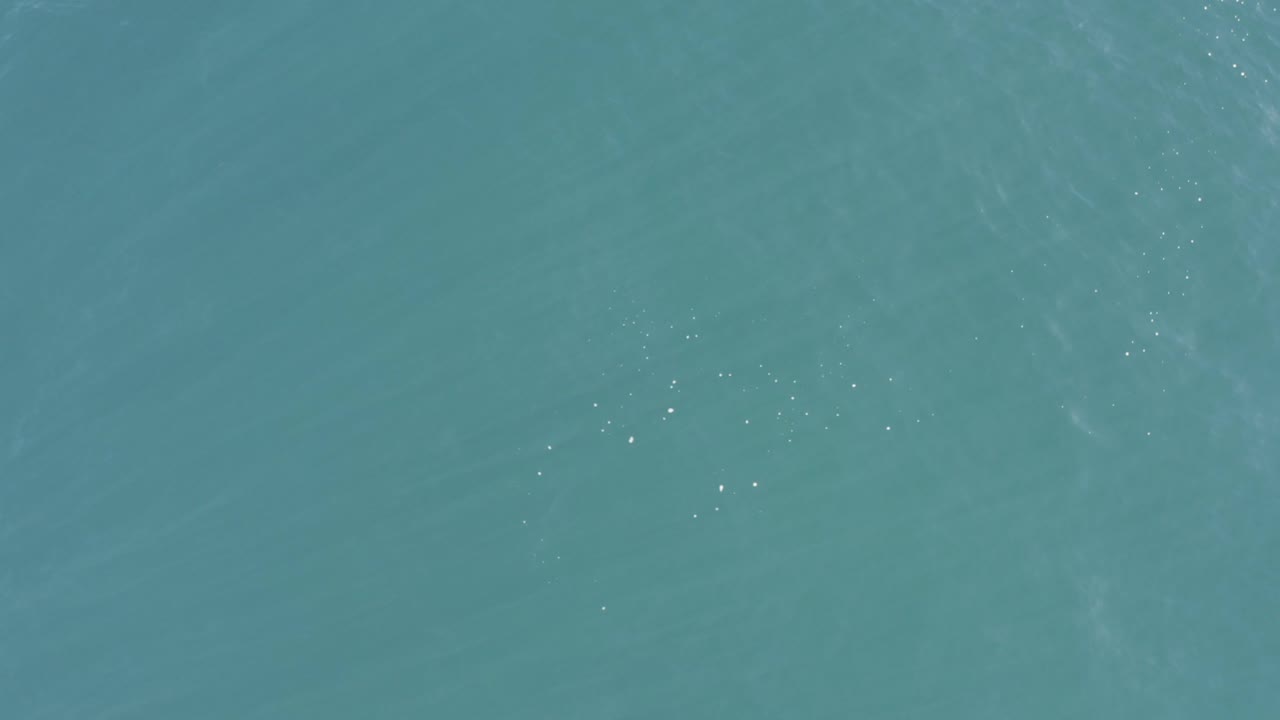 Top-down view of turquoise sea in Baja California Sur, Mexico, with faint wind ripples and no visible people.