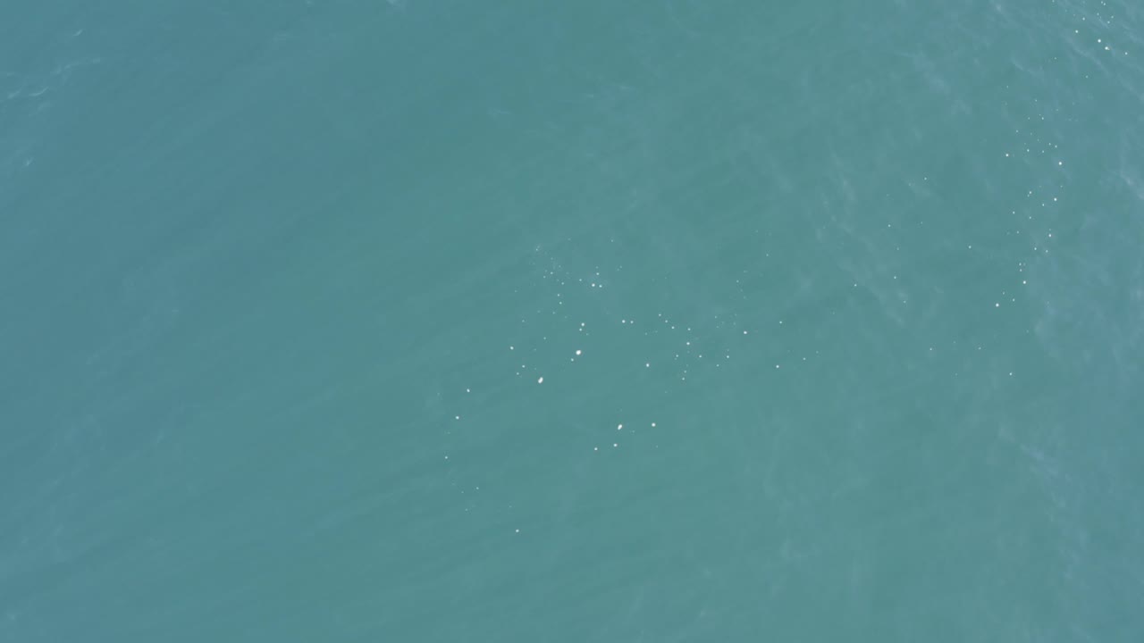 Turquoise sea in Baja California Sur, Mexico, with a slightly darker horizontal band of water texture and no visible people.