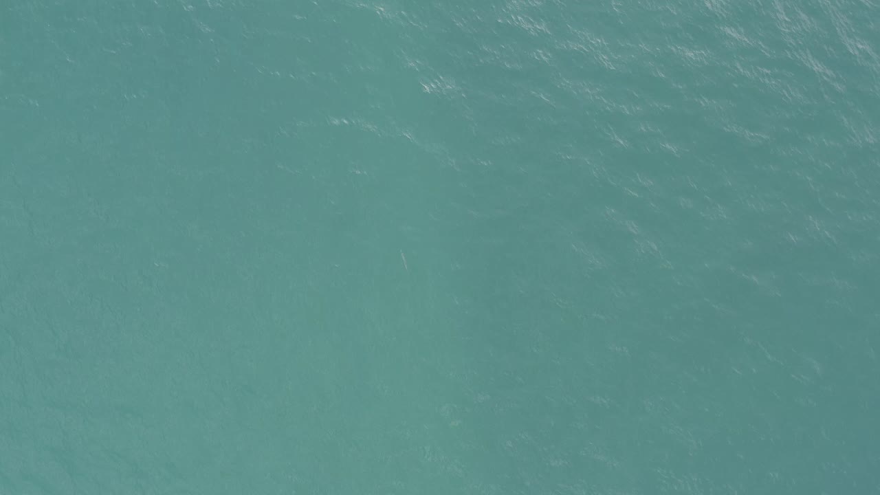 Blue-green ocean surface fills the frame in Baja California Sur, Mexico, with soft white wave marks and no visible people.