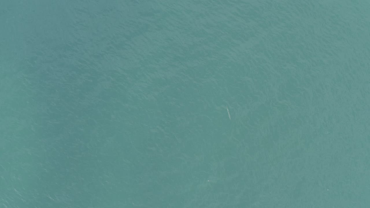 Muted teal ocean surface in Baja California Sur, Mexico, with soft tonal bands across the water and no visible people.