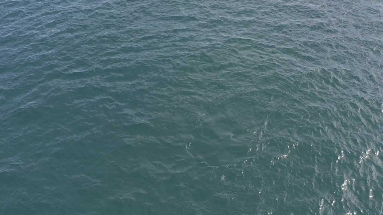 Fourth frame shows a broader patch of choppy teal water in Baja California Sur, Mexico, with pale ripple streaks crossing the surface and no visible people.
