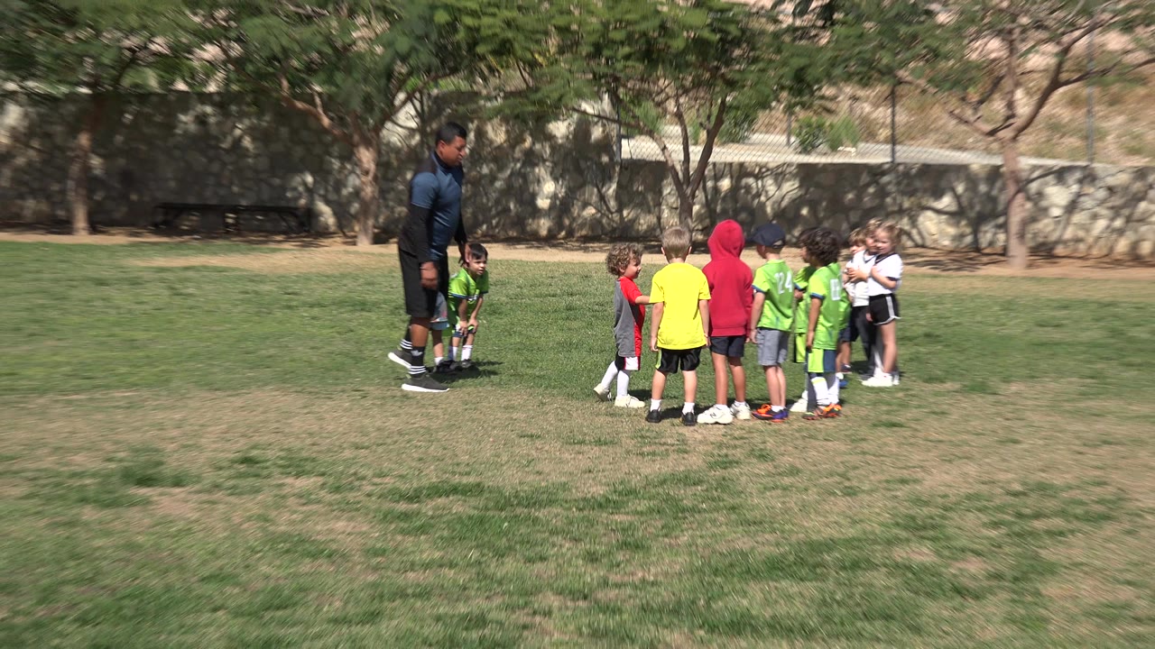 A similar wide frame shows children in green, white, yellow, and red soccer clothing grouped near an adult and a ball on the field in Los Cabos, Mexico.