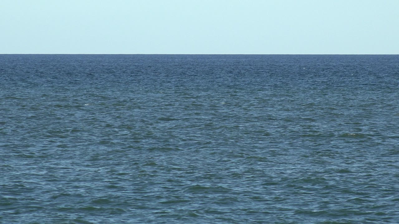Blue-green ocean surface in Los Cabos, Mexico under bright daylight, with a level horizon and no visible people.