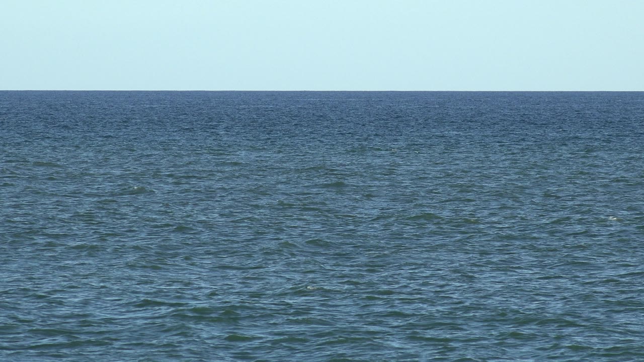Sunlit sea stretching to the horizon.