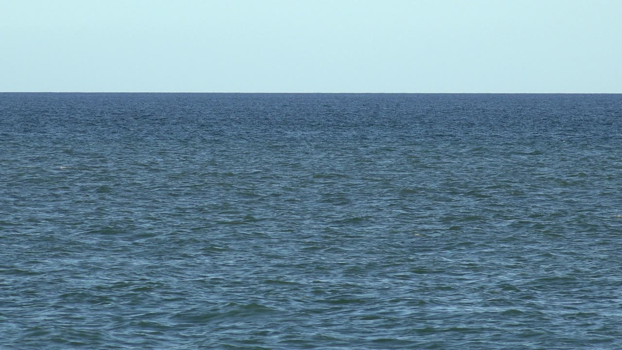 Los Cabos ocean frame with the horizon slightly above center, small wind ripples on the water, and no visible people or vessels.