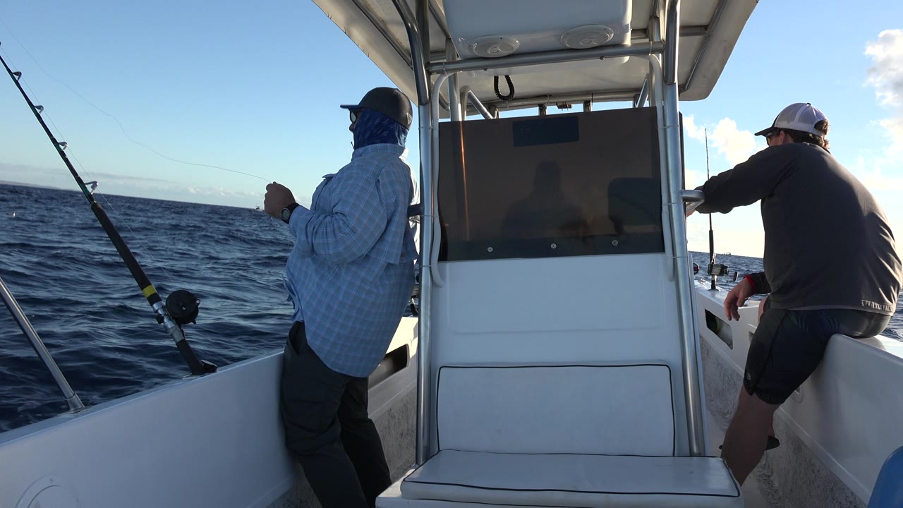 Fishing boat interior with two anglers and a slanted horizon