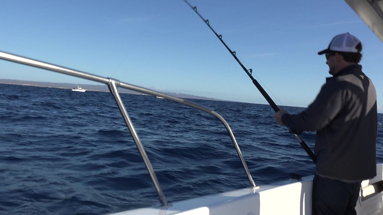 Man fishing from a small boat on open sea