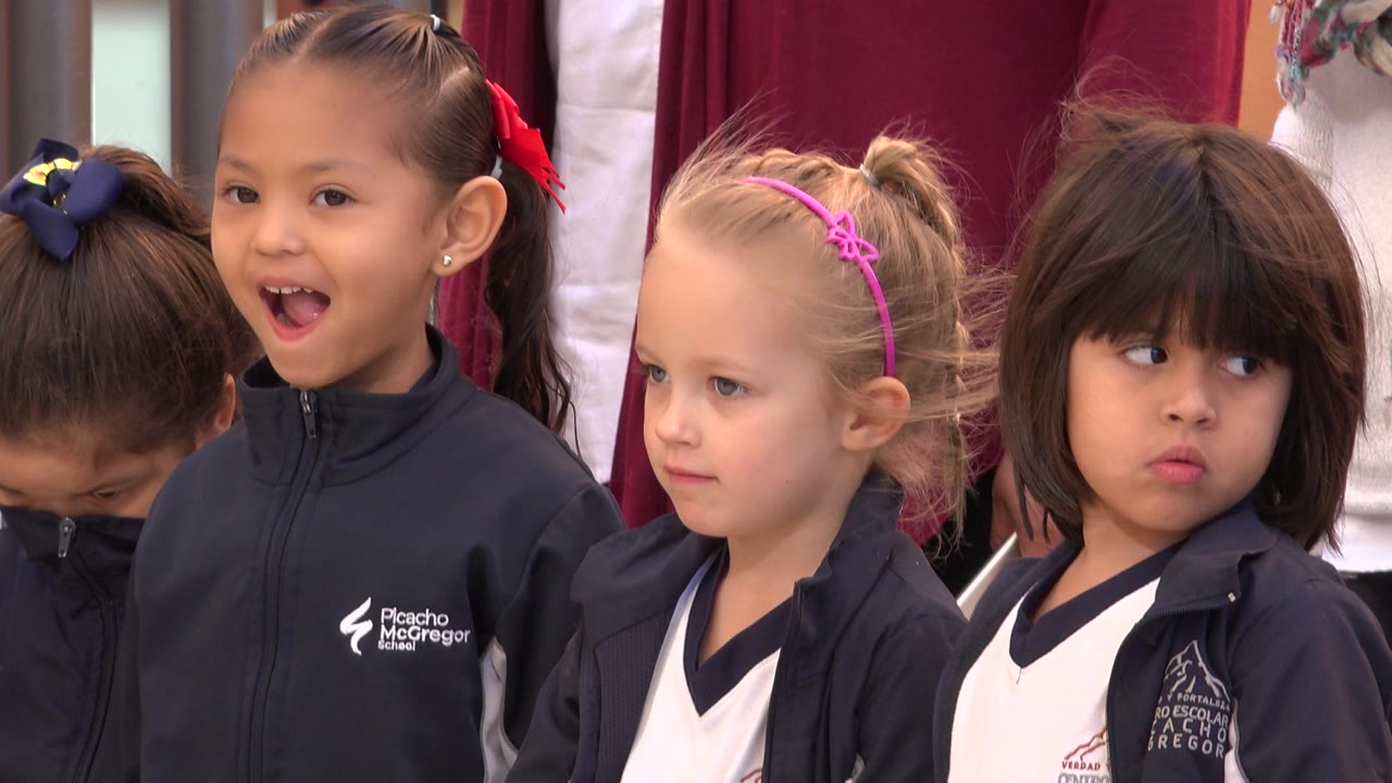 The same row of girls remains close together in San Jose del Cabo, Mexico, with one girl smiling or speaking while the others look off to the side.
