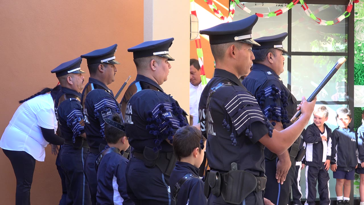 Police officers in profile with children near a doorway