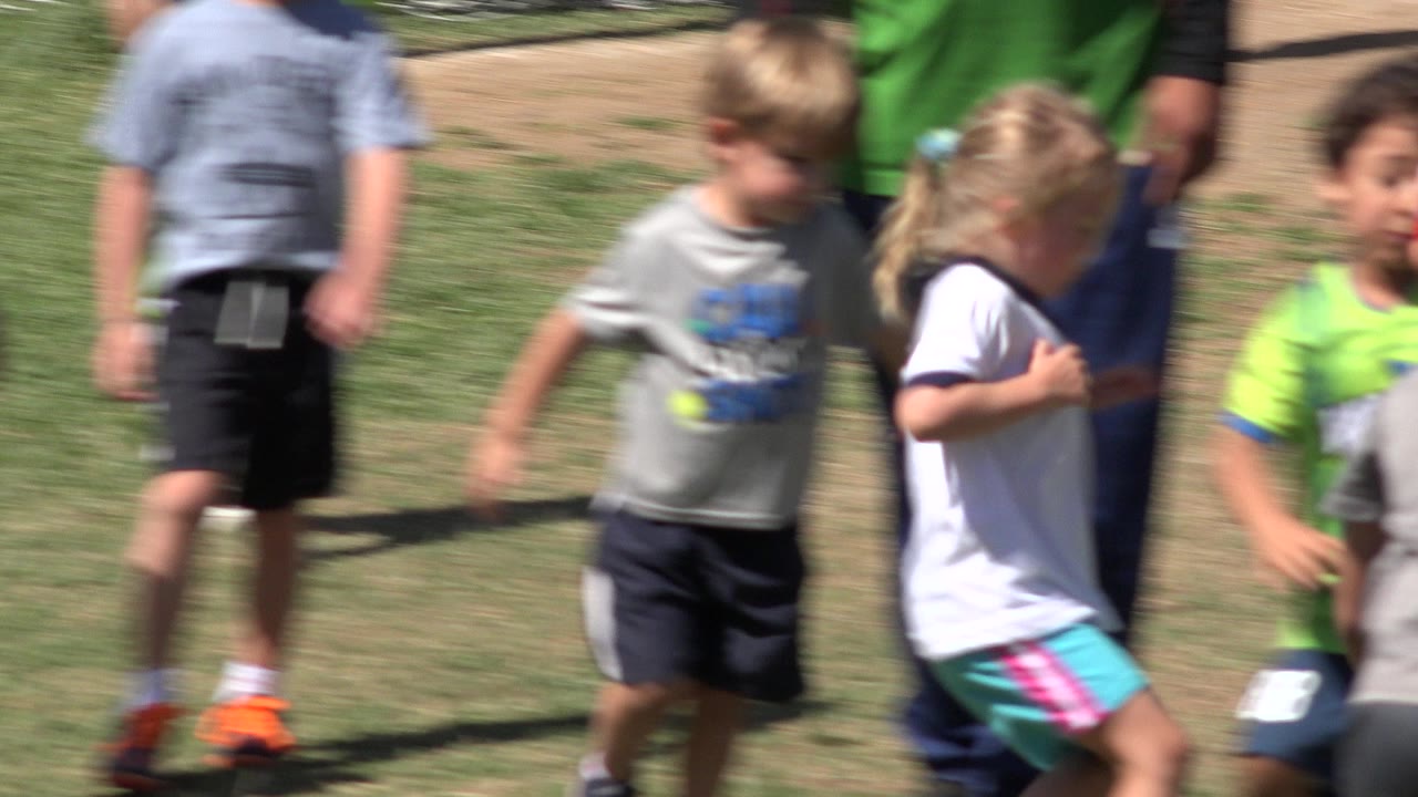 Children blurred while running on a field.
