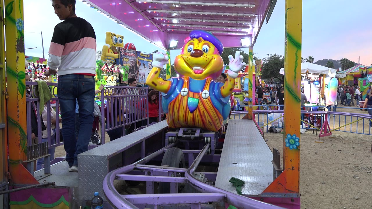 Caterpillar coaster car is close to the ride platform.