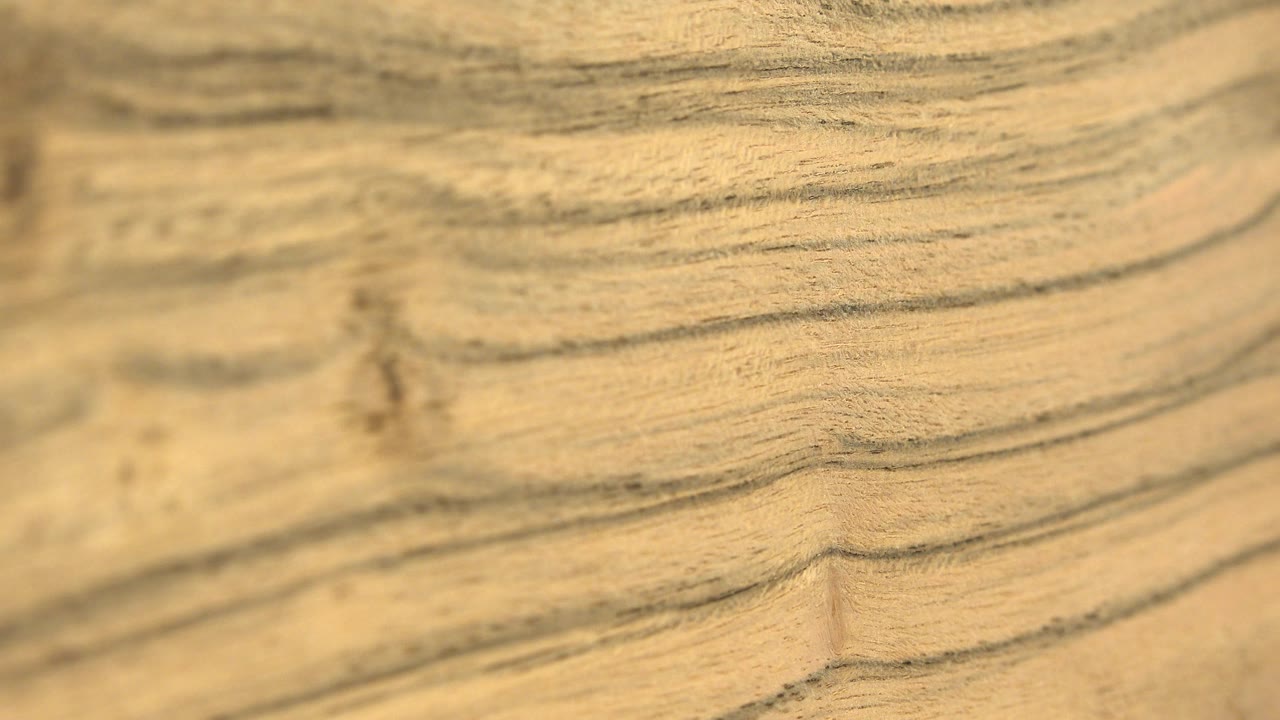 Soft, grainy view of the tan topography-like image in Westminster, Colorado, with a darker vertical crease near the middle and no visible people.