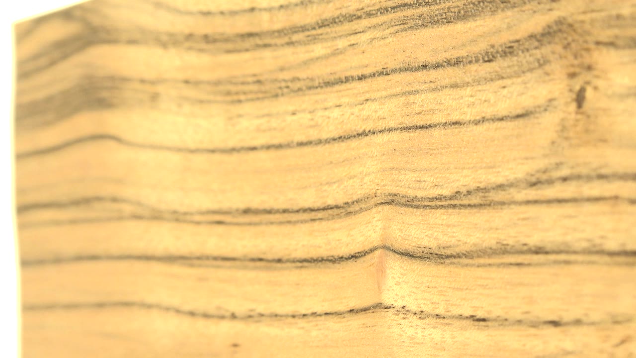 Wood grain close-up beside a pale vertical edge.