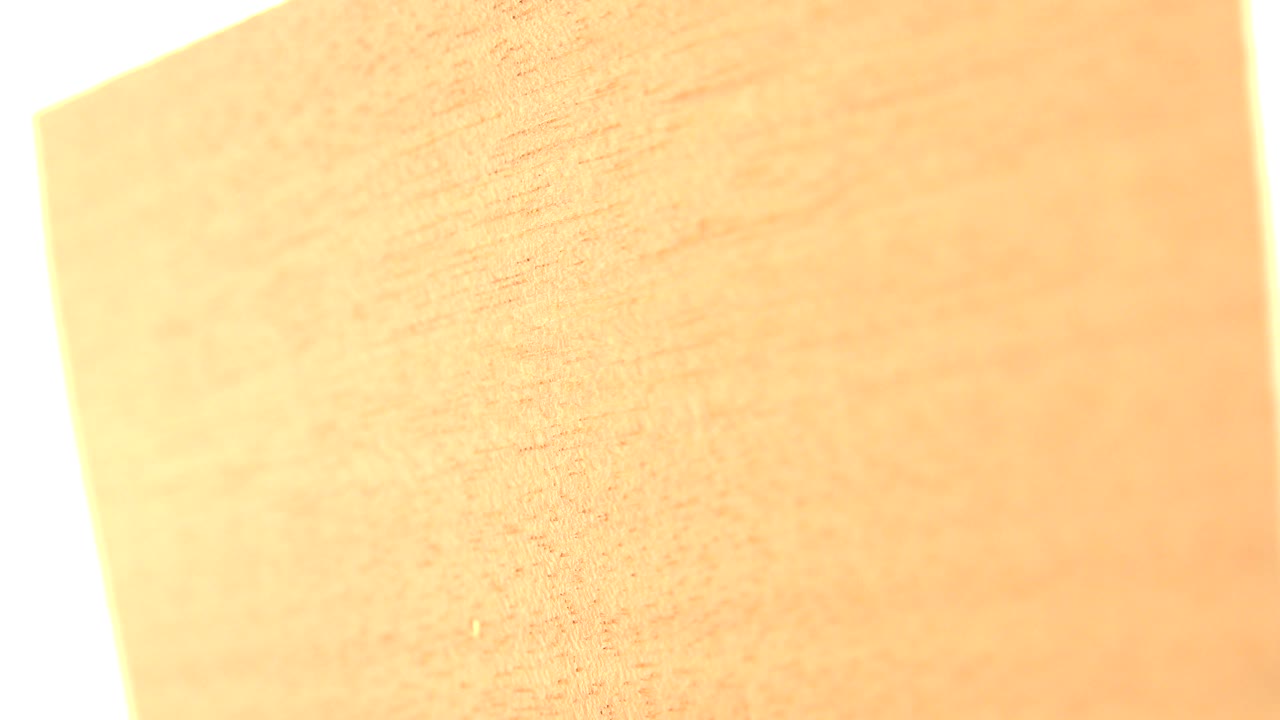 A second Westminster, Colorado frame shows the broad face of the yellow wood board, with a pale vertical background strip at one side and no visible people.