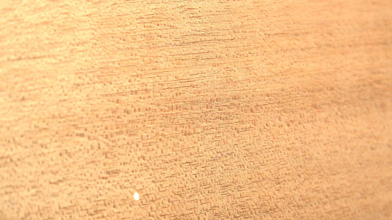 The rotating board shows dense tan striations across the frame in Westminster, Colorado footage, with a small bright dot lower in the image and no visible people.