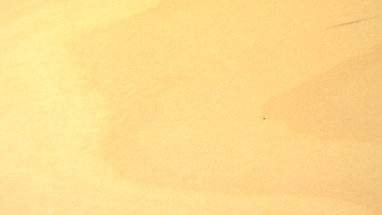 Warm gold reflective surface under bright light