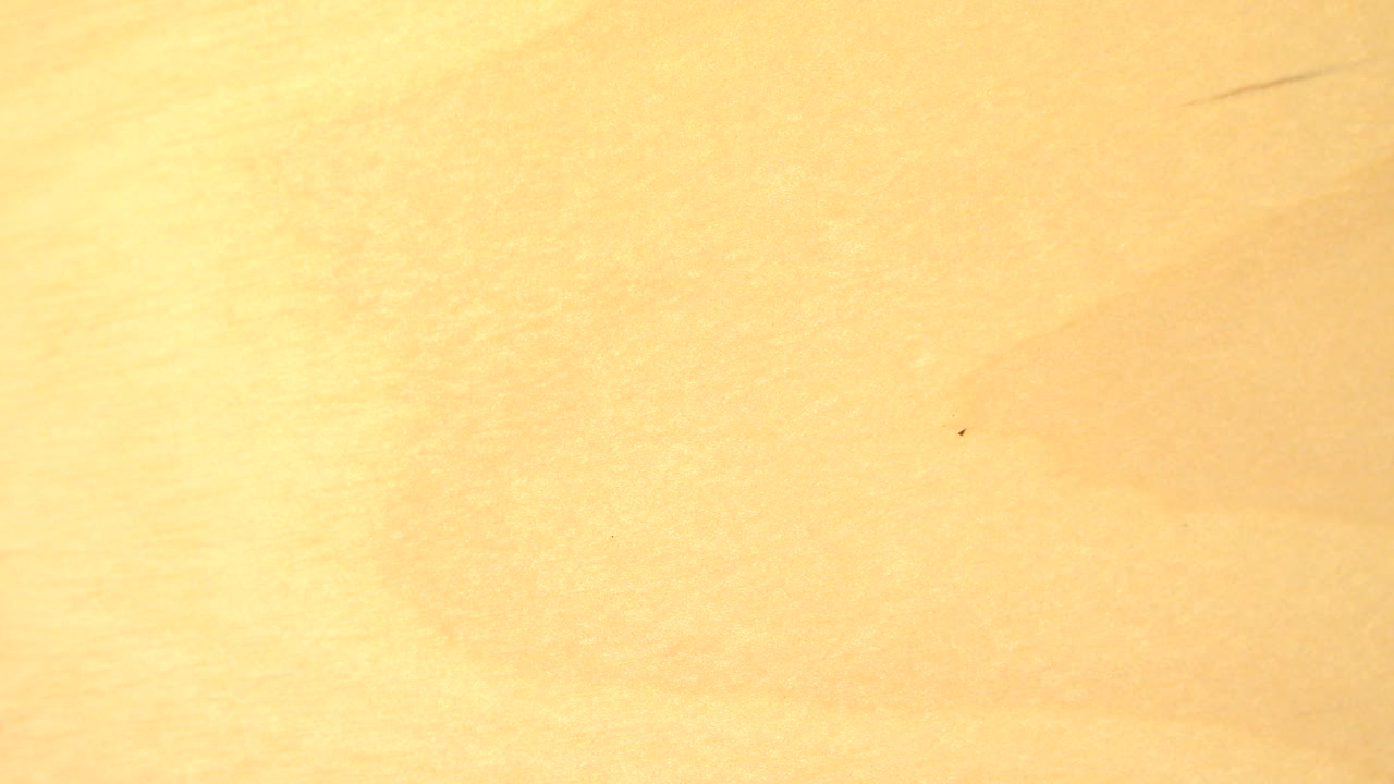 A gold reflective surface remains close to camera with faint marks and bright glare in this Westminster, Colorado frame, with no visible people.