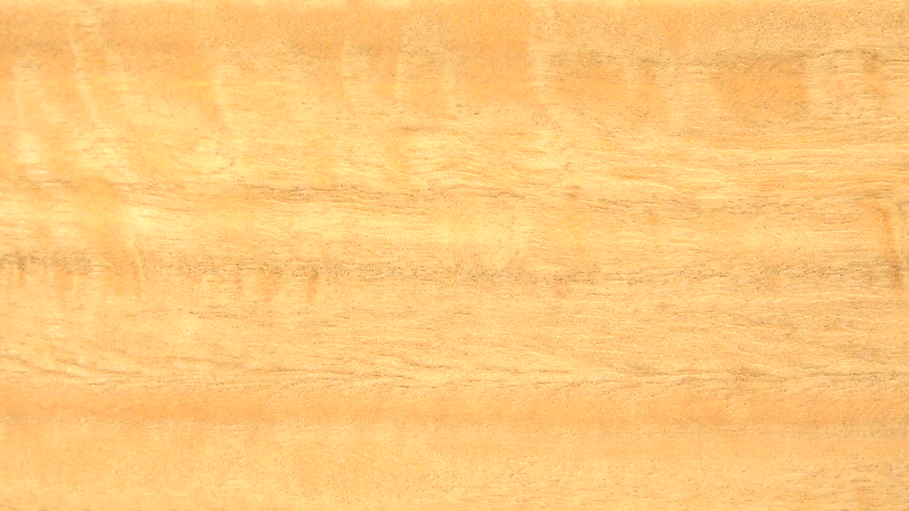 Glossy amber wood grain filling the frame