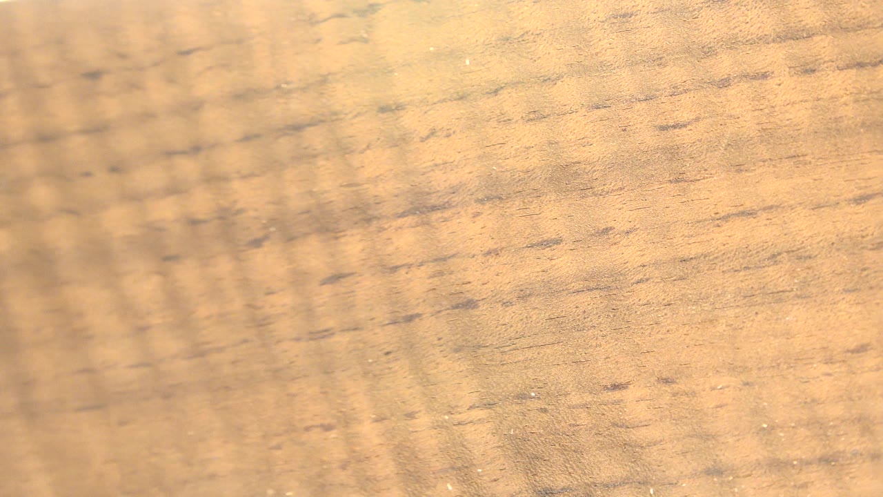 Blurred wood grain with vertical light pattern.