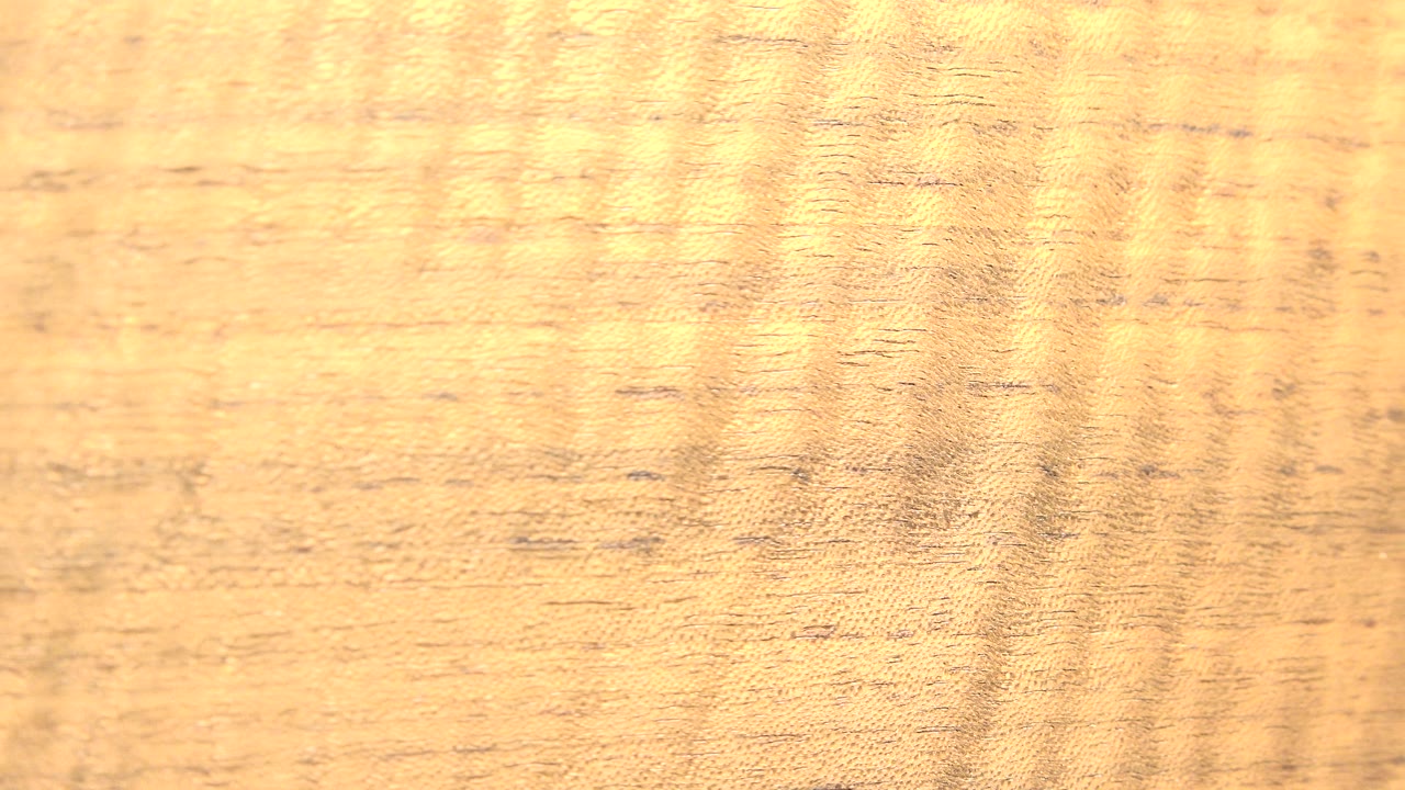 A close view of a warm brown textured surface from the Westminster, Colorado 2015 clip fills the frame with subtle darker grain and no visible people.