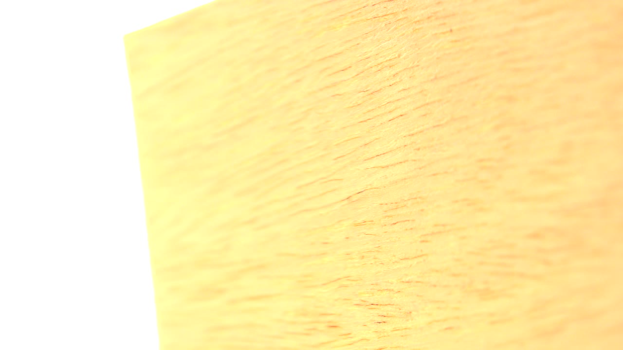 At 0:00, a yellow wood-grain surface fills the upper frame against a blown-out white background in Westminster, Colorado, with no visible people.