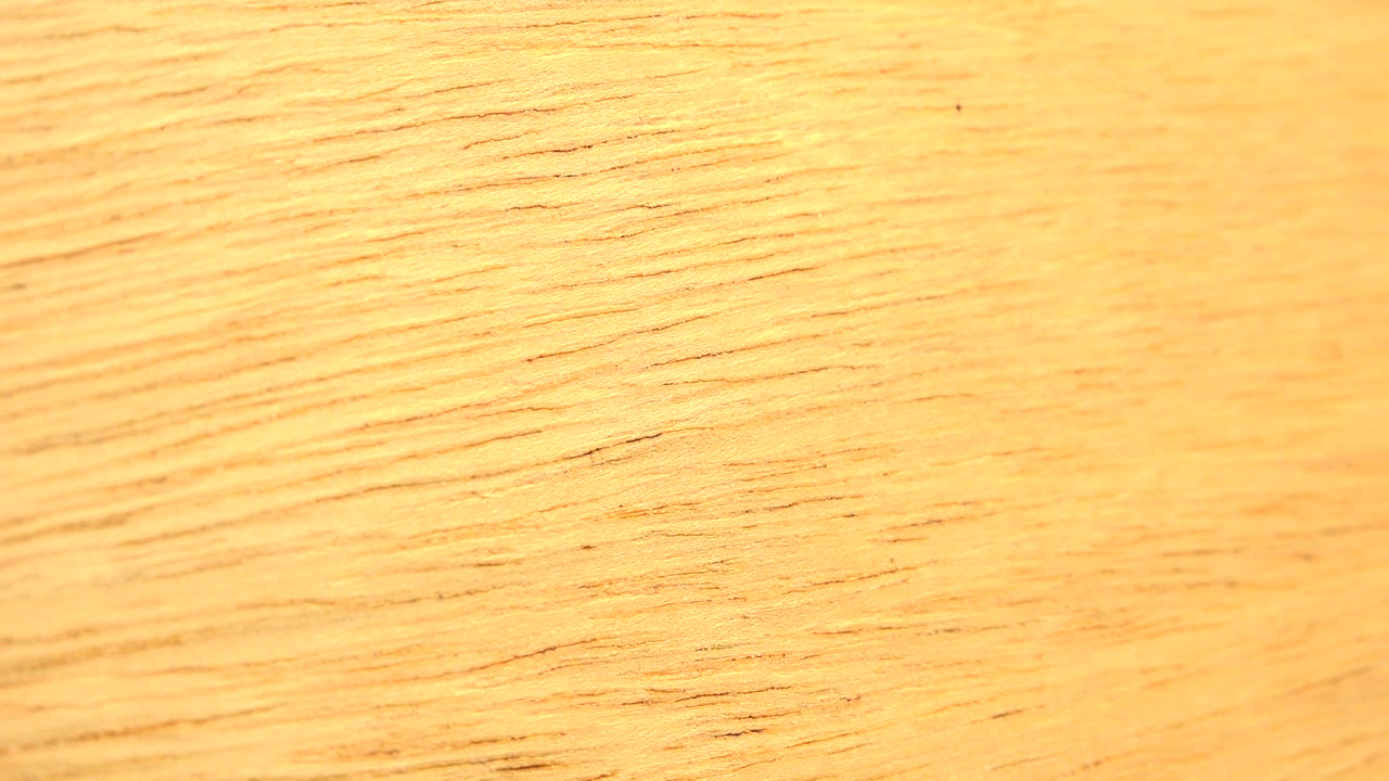 Warm yellow-brown wood grain fills the first frame of the Westminster, Colorado clip, with no visible people.