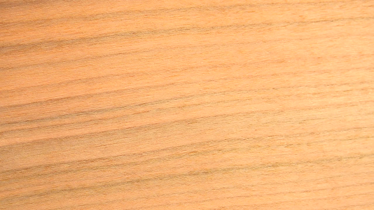 Close-up of honey-orange wood grain in Westminster, Colorado footage, with fine horizontal lines and no visible people.