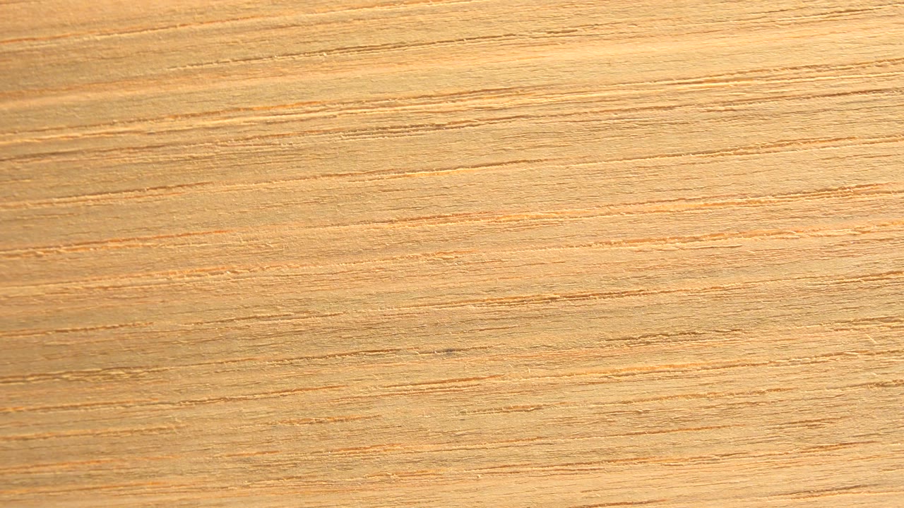Tan wood grain fills the frame.