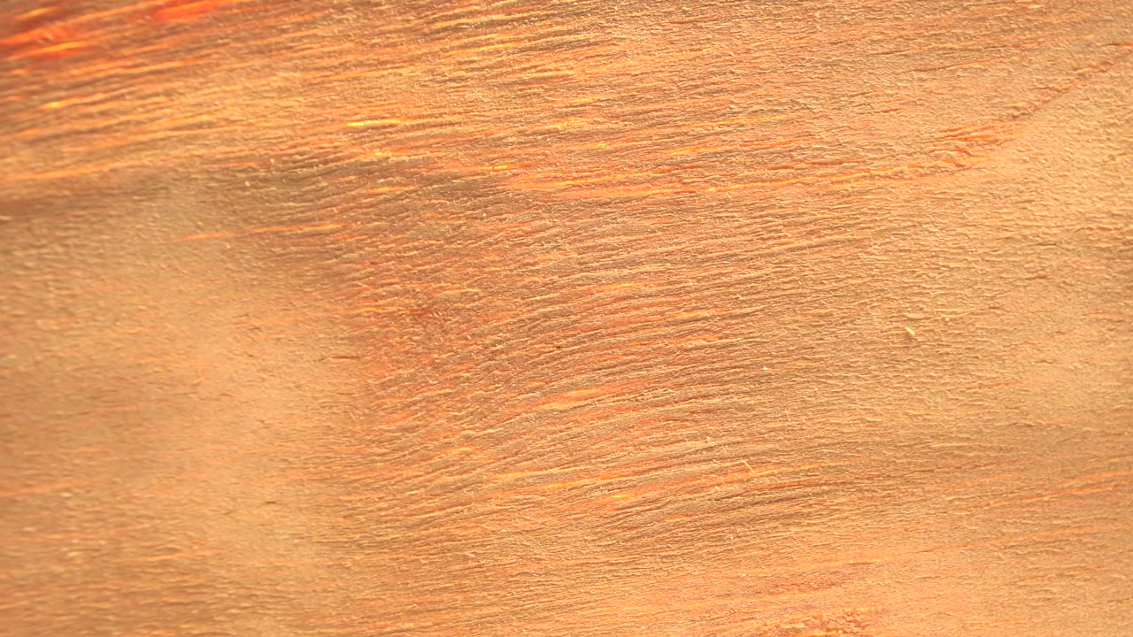 Close-up wood grain fills the Westminster, Colorado frame with warm orange-brown texture and no visible people.