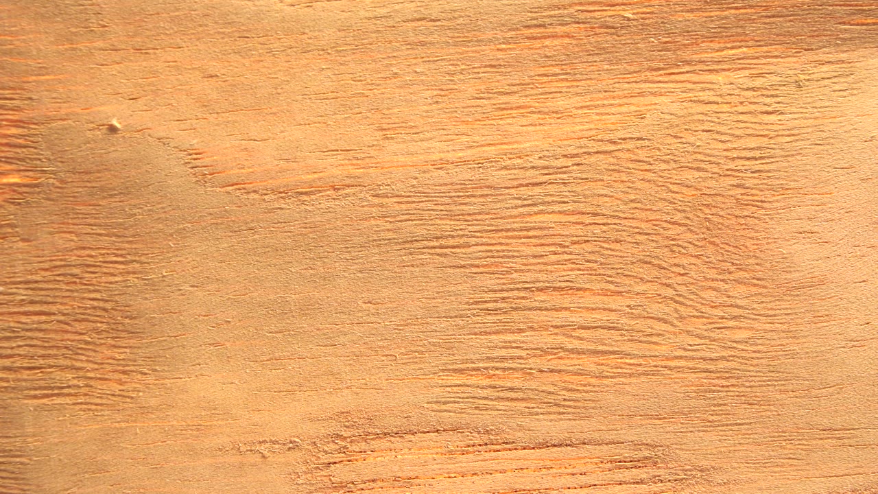The second frame holds on a gold-orange textured area with more visible streaking across the center and no visible people.