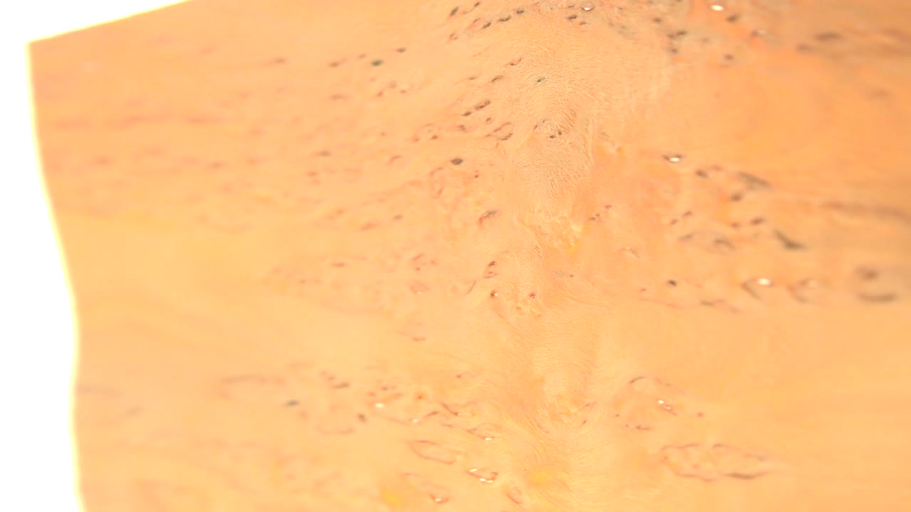 Extreme close-up of a yellow translucent surface with bright white edge light.