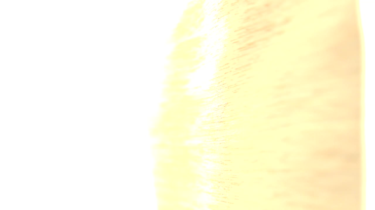 Overexposed close-up of warm flowing texture against white light.