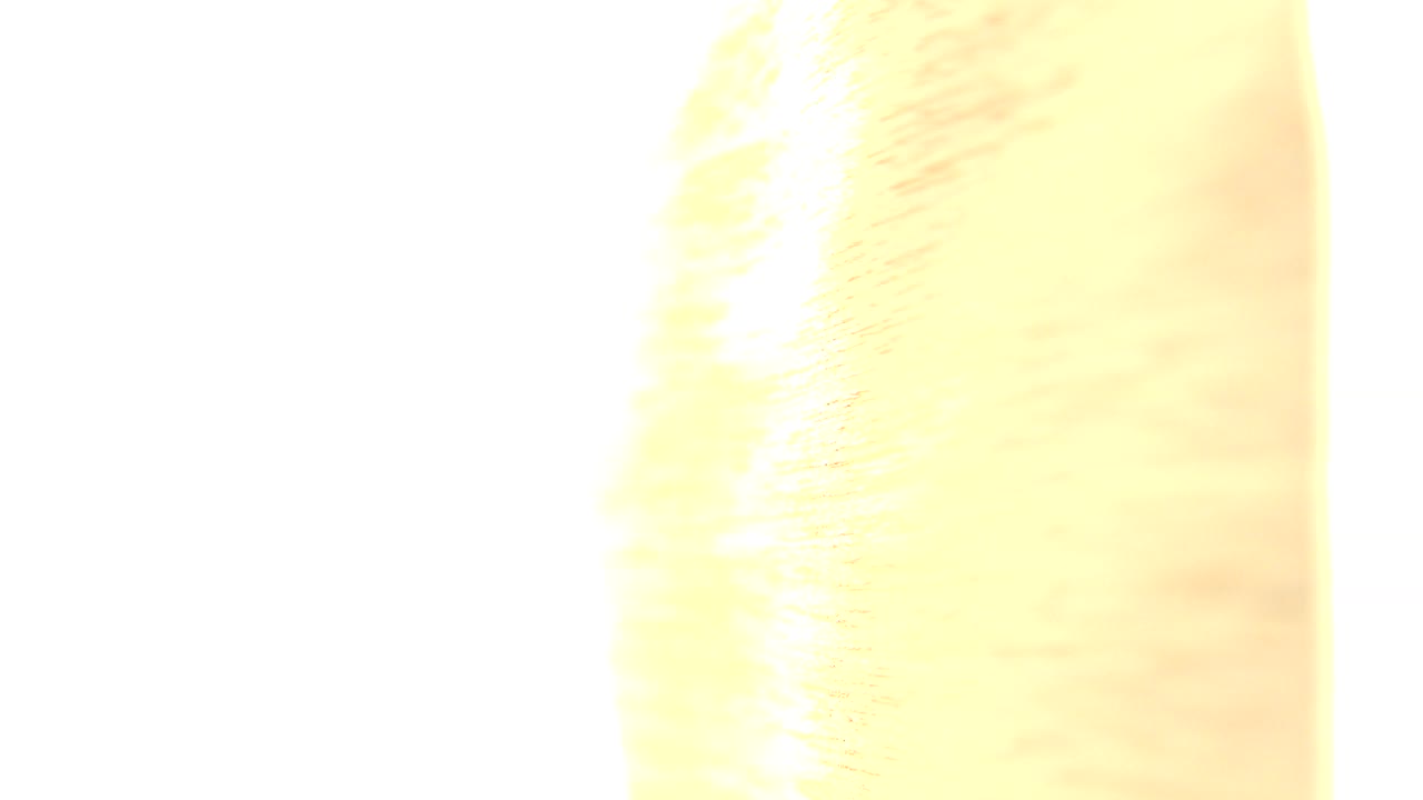 At 0:01 in Westminster, Colorado, the frame remains mostly white from strong daylight with a warm blurred vertical texture along the right edge, and no recognizable face visible.