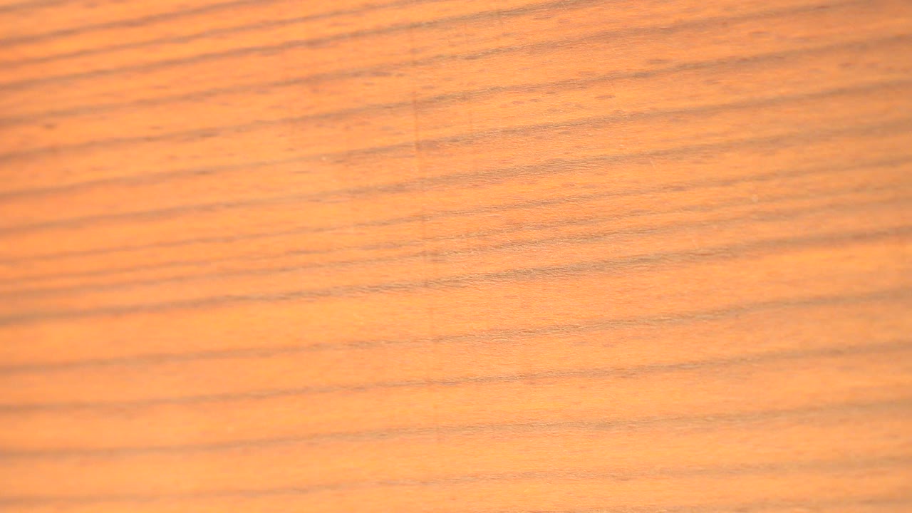 Close view of warm orange wood grain in Westminster, Colorado, with horizontal lines across the frame and no visible people.